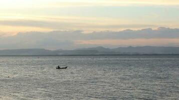 Fisherman Silhouette on His Boat photo