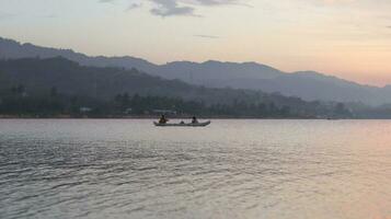 Fisherman Silhouette on His Boat photo