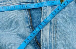 Jeans and centimeter, weight loss concept photo