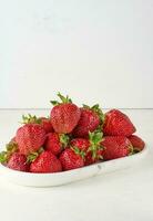 Ripe red strawberry on white background photo