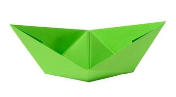 Green paper boat on a white isolated background photo