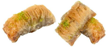 Pieces of baked baklava in honey on a white isolated background photo