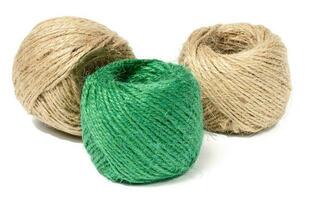 Brown and green skeins of jute rope on a white isolated background photo