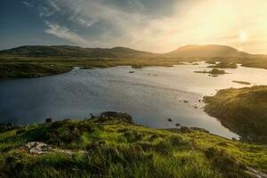 Breathtaking sunset scenery with lake and mountains at Connemara National park in County Galway, Ireland photo