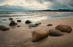Dramatic cloudy sunset coastal landscape scenery of sandy Silverstrand beach in County Galway, Ireland photo