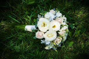 beautiful wedding flowers bouquet on green grass photo