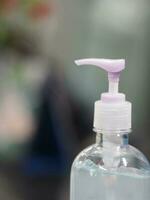 Hand Sanitizer, gel alcoholic mixture with gelatin in clear Plastic bottle with pump pushing wash clean dirty to prevent germs protect Contagious disease corona virus, covid-19 photo