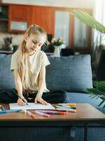 Child girl drawing with colorful pencils photo