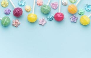 Sweet lollipops and candies on blue background photo