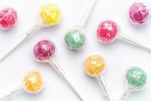 Sweet lollipops on white background photo