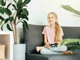 Girl playing video game at home photo