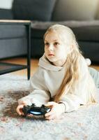 Girl playing video game at home photo