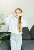 Cute little girl listening to music in headphones photo