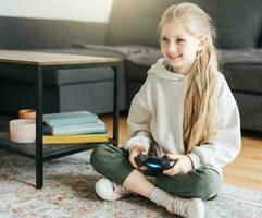 Girl playing video game at home photo