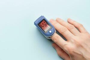 Pulse oximeter measuring oxygen saturation in blood and heart rate photo