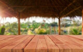 perspective wooden board over blurred green farm photo