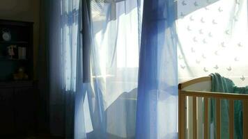 Empty baby boy room. Blue transparent curtains at decorated window in the background video