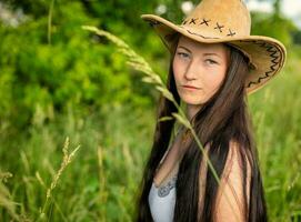 woman with cowboy hat in nature photo