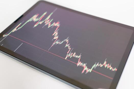 digital tablet display stock market data with graph and chart for analyze and check before trading stocks online photo