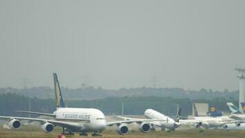 FRANKFURT AM MAIN, GERMANY JULY 20, 2017 - Lufthansa Airbus 340 D AIGN in Star Alliance livery rotate and climb up at runway 25C. Singapore Airlines A380 at foreground. Fraport, Frankfurt, Germany video