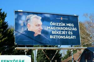 Budapest, Hungary March 24, 2022, Let's preserve the Peace and Security of Hungary. FIDESZ Propaganda Parliamentary Election Campaign Poster with Picture of Prime Minister Viktor Orban photo