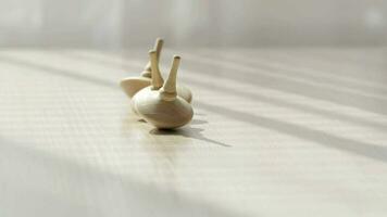 Two spinning top moving on a table. Closeup video