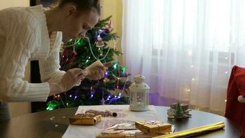 Young lady between 30 and 35 years old prepares Christmas gifts for her relatives video