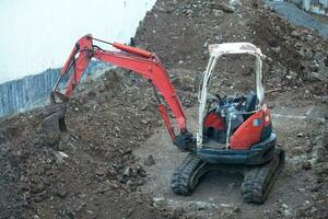 Mini excavator on a construction site photo