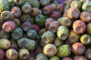 Stack of prickly pears on a market stall photo