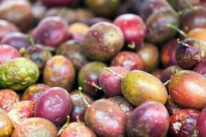 Stack of passion fruits on a market stall photo