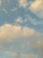 Beautiful white clouds on deep blue sky background. Large bright soft fluffy clouds are cover the entire blue sky. photo