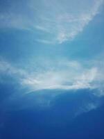 Beautiful white clouds on deep blue sky background. Large bright soft fluffy clouds are cover the entire blue sky. photo