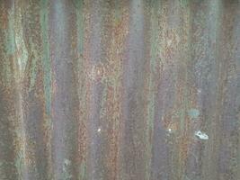 Artistic of old and rusty zinc sheet wall. Vintage style metal sheet roof texture. Pattern of old metal sheet. Rusting metal or siding. Corrosion of galvanized. Background and texture in retro concept photo