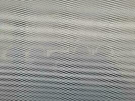 Selective focus, close-up view at One Way Vision sticker film with dot pattern on glass of window photo
