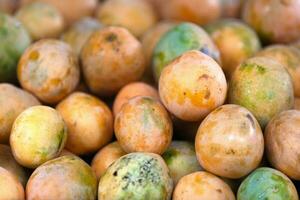 Stack of mangoes for sale on a market stall photo