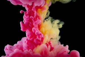 Pink and yellow paint swirling underwater photo