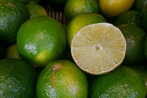 Stack of limes on a market stall photo