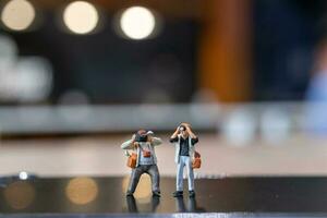 Miniature people Photography holding a camera and copy space for text photo