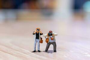 Miniature people Photography holding a camera and copy space for text photo