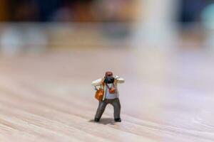 Miniature people Photography holding a camera and copy space for text photo