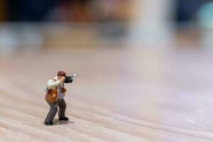 Miniature people Photography holding a camera and copy space for text photo