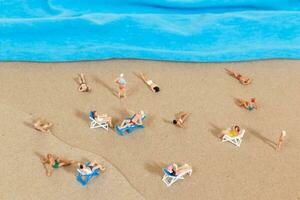 A tiny person in a swimsuit is relaxing on the beach in the summer photo