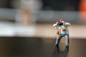 Miniature people Photography holding a camera and copy space for text photo