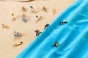 A tiny person in a diving suit on the beach in the summer photo