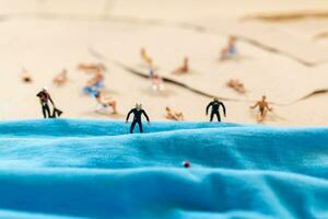 A tiny person in a diving suit on the beach in the summer photo