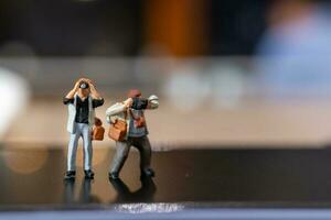 Miniature people Photography holding a camera and copy space for text photo