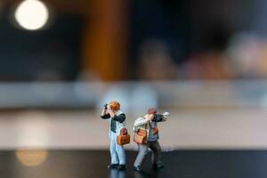 Miniature people Photography holding a camera and copy space for text photo