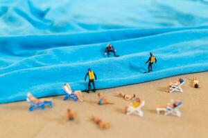 A tiny person in a diving suit on the beach in the summer photo