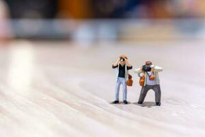 Miniature people Photography holding a camera and copy space for text photo