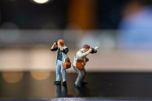 Miniature people Photography holding a camera and copy space for text photo